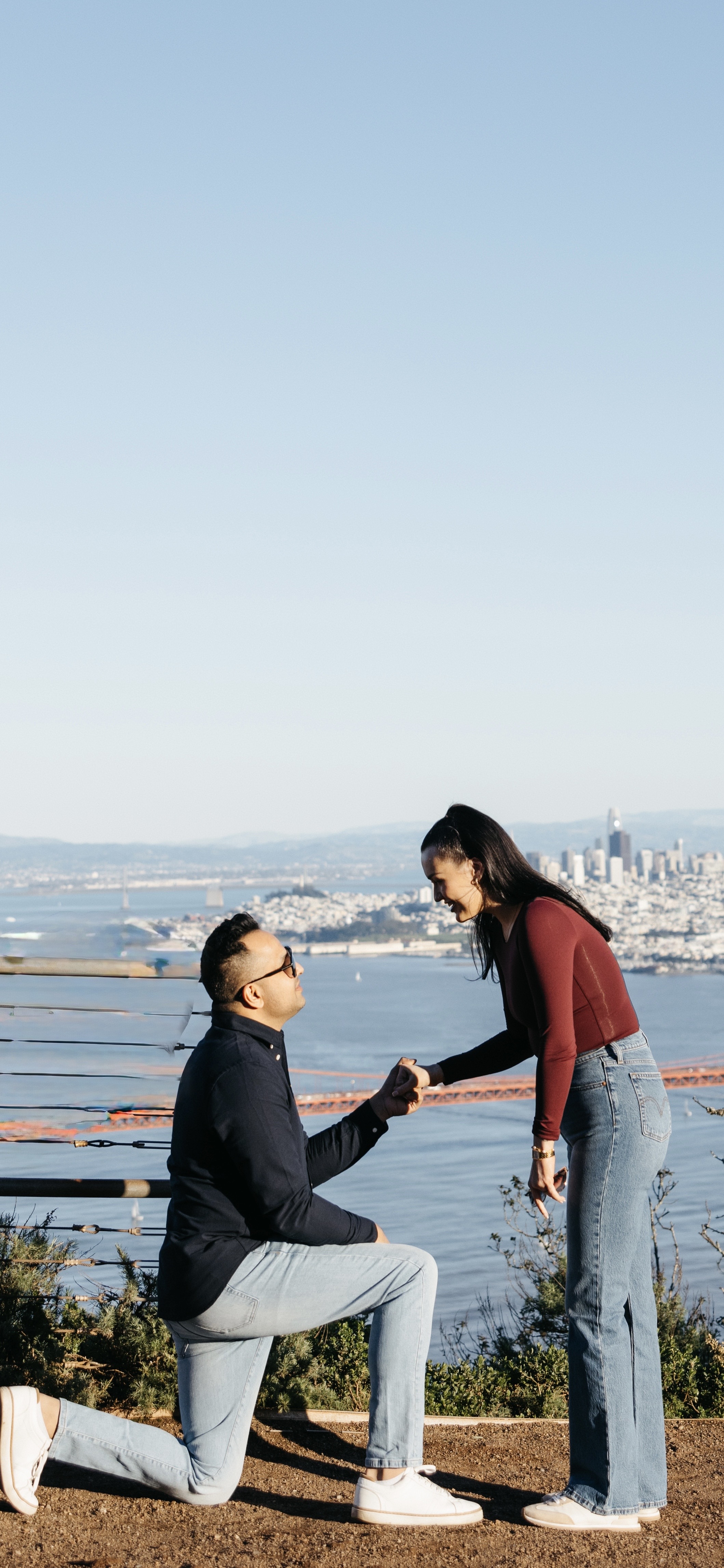Manoj proposing to Brynn with the Golden Gate Bridge behind them