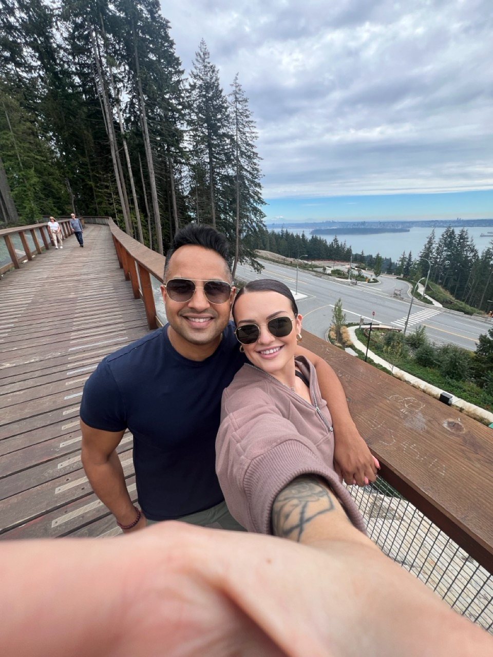 Brynn and Manoj on the Cypress Mountain boardwalk overlooking Vancouver